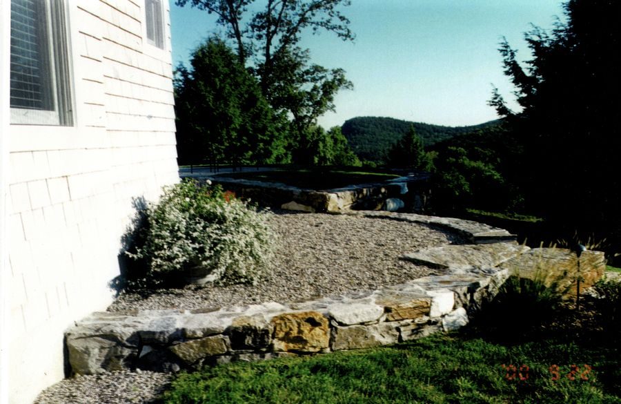 Stone wall curving along hillside property